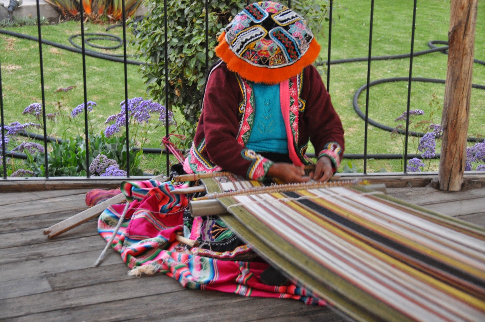 This woman is demonstrating the traditional style of Peruvian weaving.