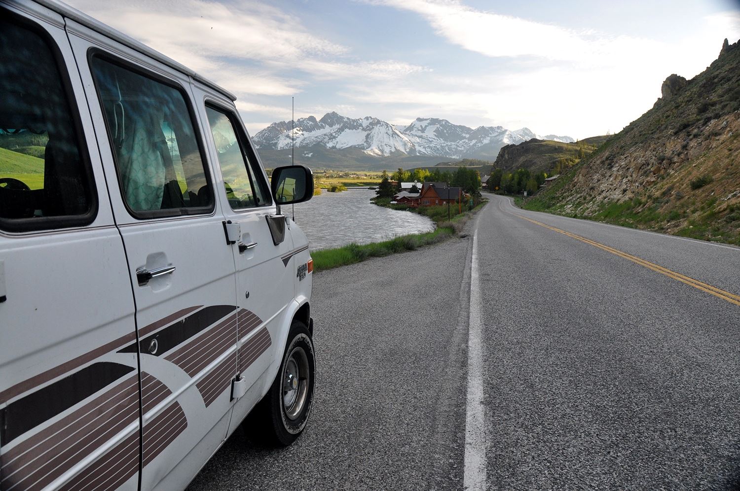 Cheap Road Trip Tips Van on Highway Mountains