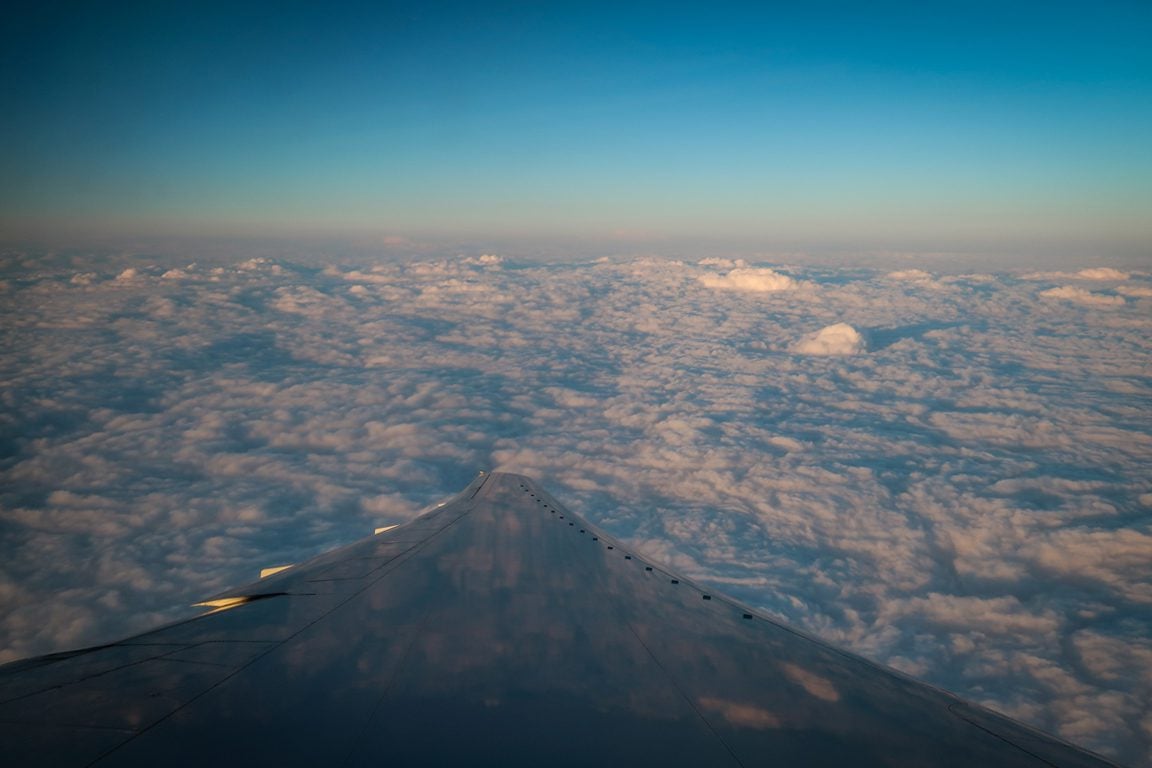 Travel Credit Cards Airplane Wing in Clouds