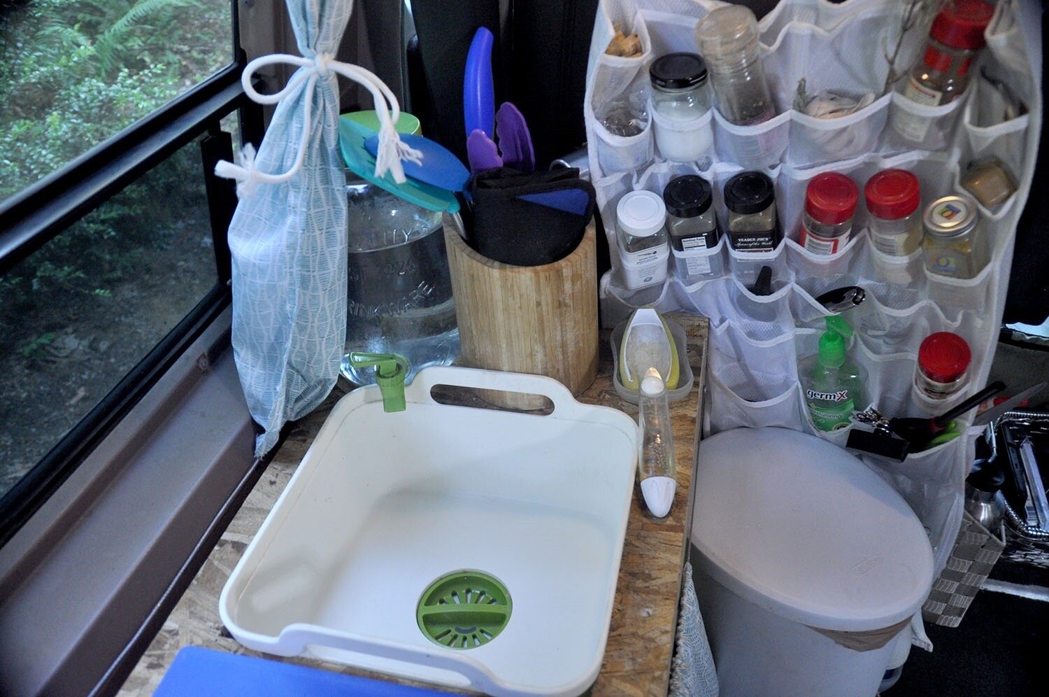 This was the kitchen in our first campervan build, and this picture shows an example of a gravity-fed water jug. (See below for the link to the exact sink we used.)
