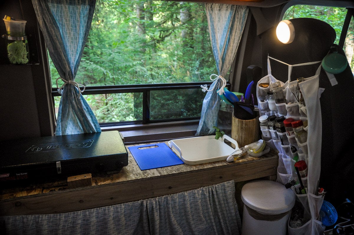 Our first campervan kitchen was nothing fancy so the plywood countertops were perfect. They were very functional and inexpensive. Tip: We always kept that blue cutting board in place with an exposed screw that we’d place the handle over.