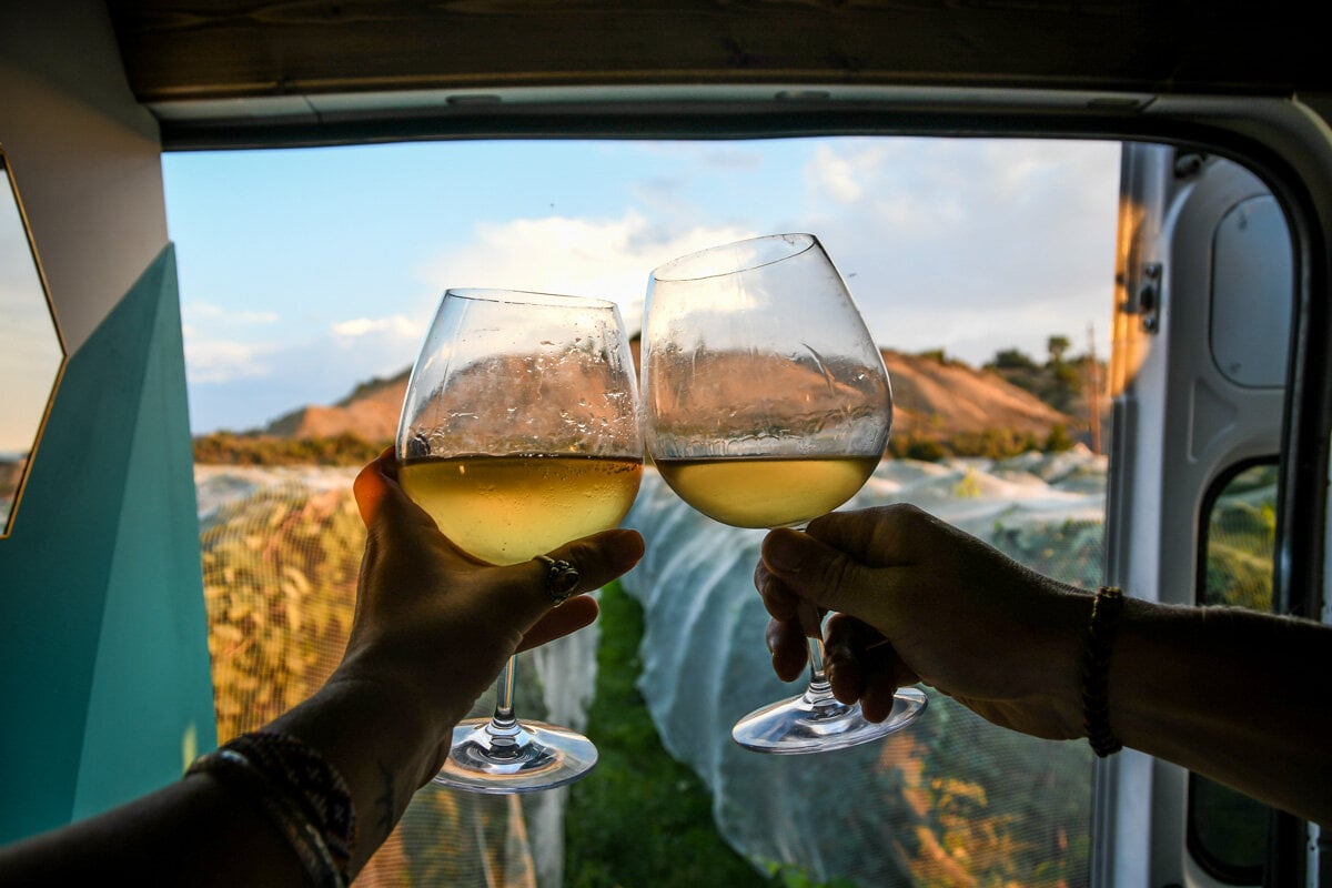 Enjoying sunset wine from the SOURCE! As you can see, the grapes were covered with netting while we were there to deter birds, but it was still a pretty unique place to wake up!