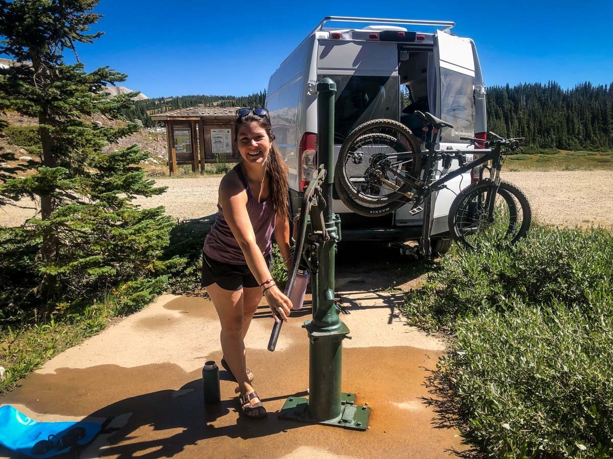 Most water fill stations have a way to connect a hose, making this process much easier. However, every once in a while, we’ve had to fill at places where there’s no hose attachment… In this particular situation, we had to manually pump the water into bottles and then fill our tank, one by one.