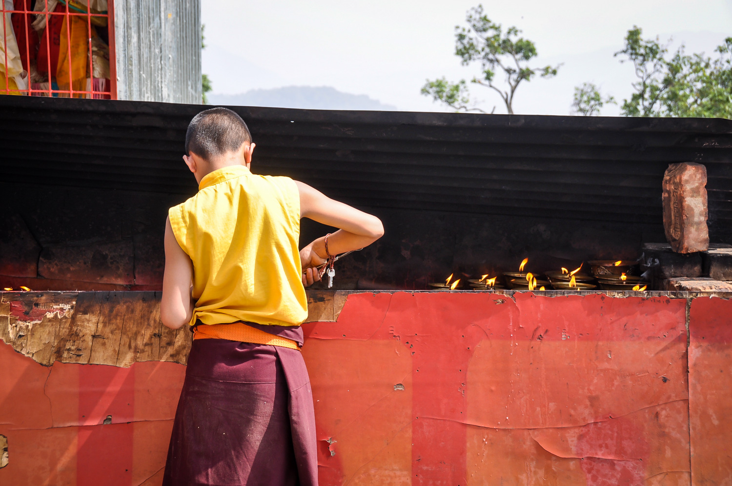 Nepal Travel Guide Monk Cleaning Candles