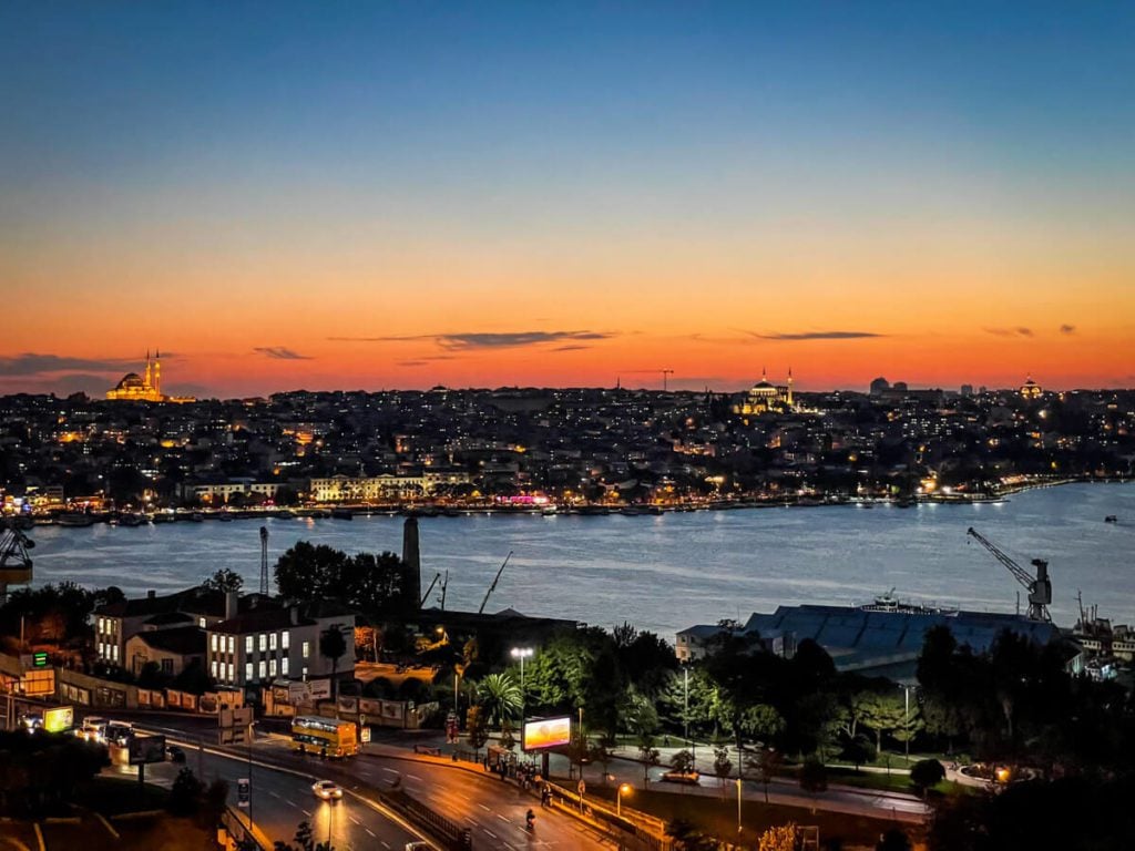 2 Guys talking on a wall waiting to cross the Bosphorus, Istanbul, Turkey