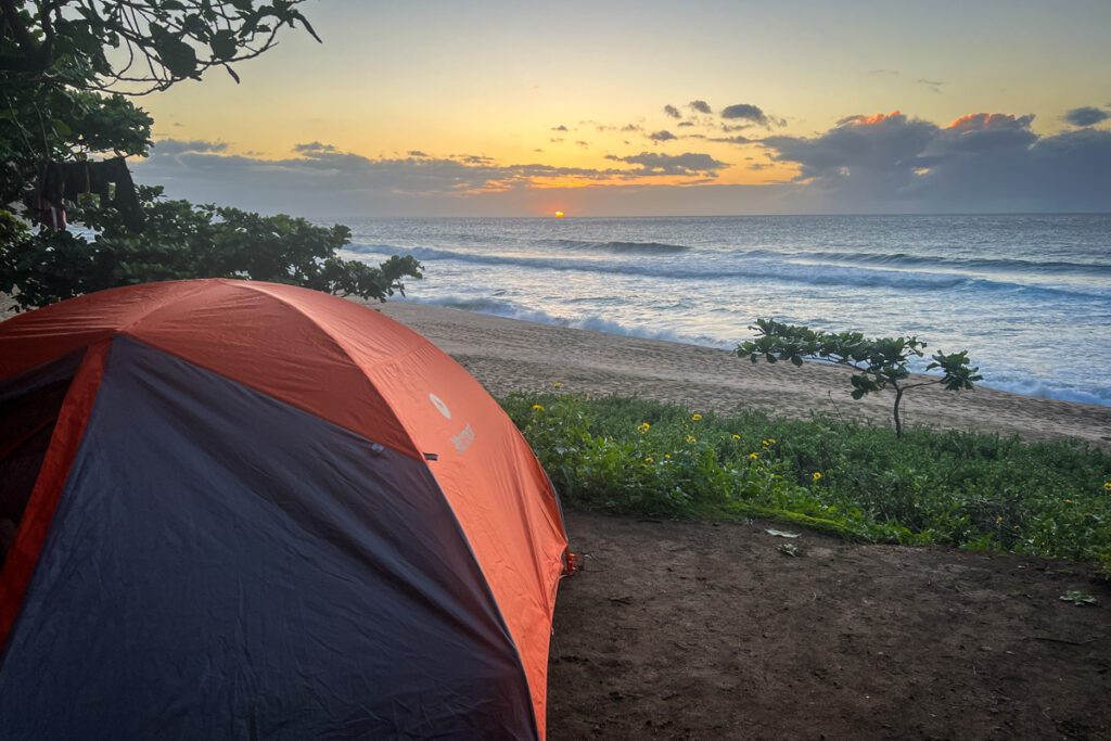 Beach camping in Hawaii at sunset