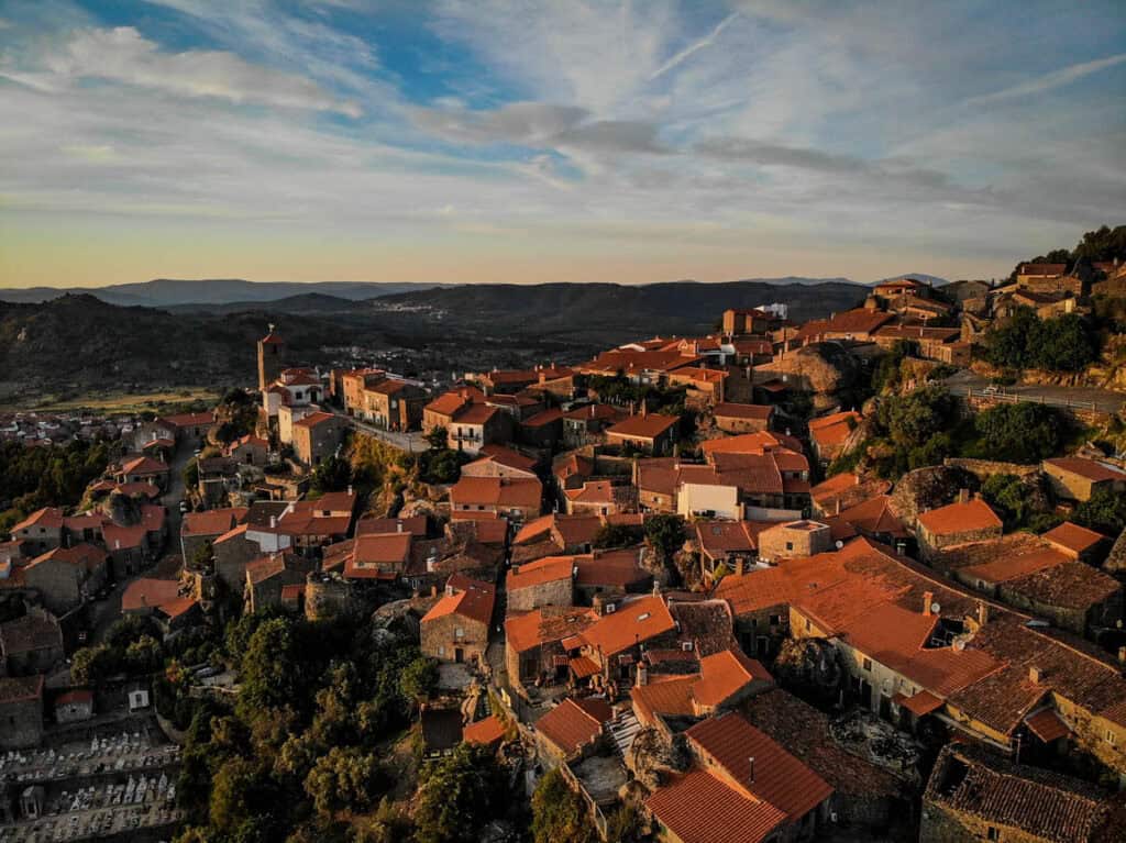 A drone shot of Monsanto, Portugal  at sunset