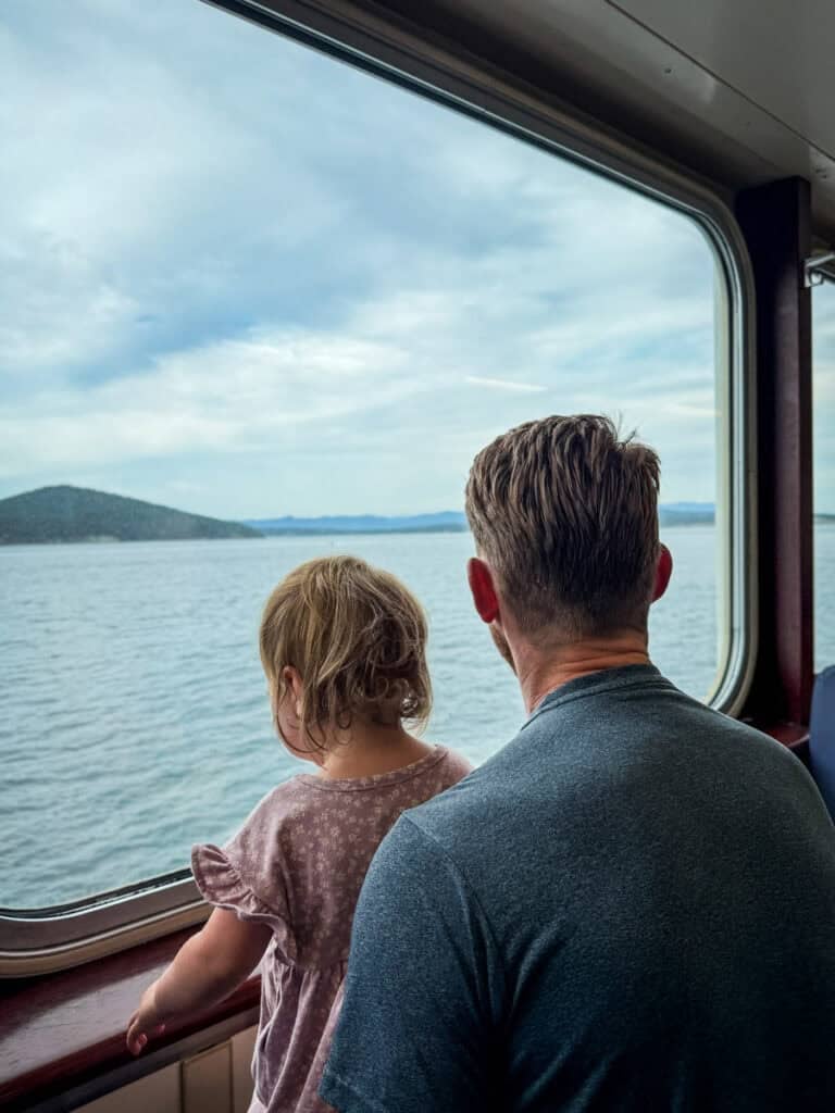 Washington State Ferry Father and Daughter looking out window San Juan Islands WA